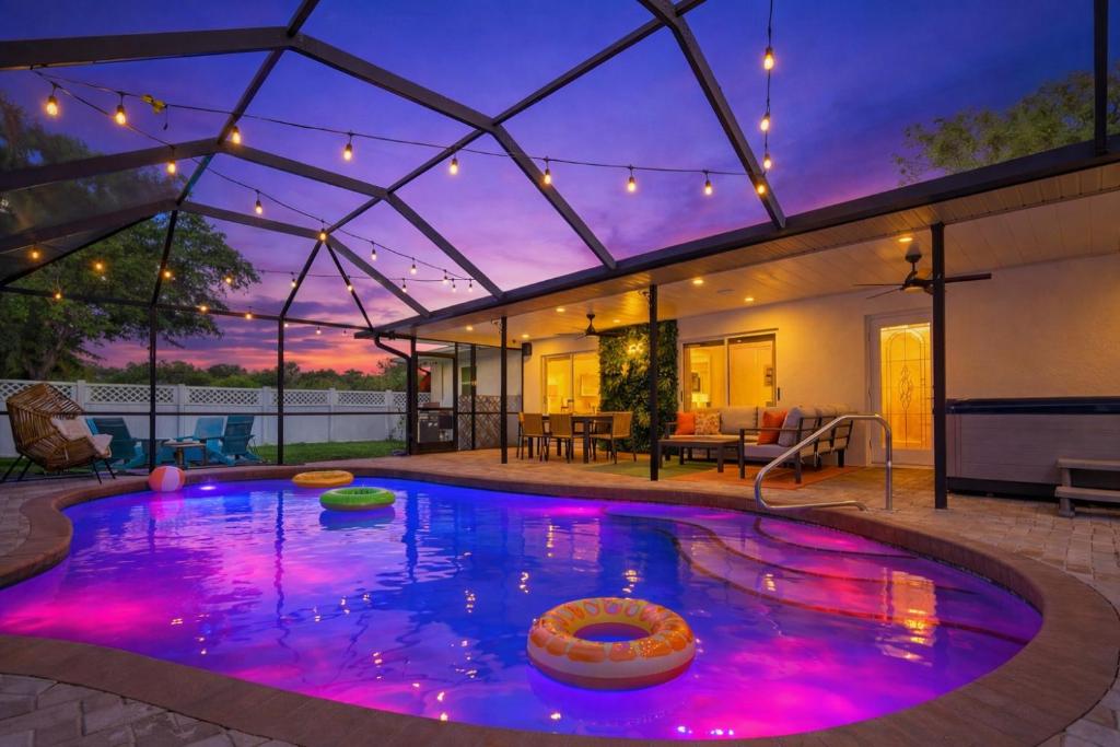 a swimming pool with purple lights in a house at The Mimosa House in Sarasota
