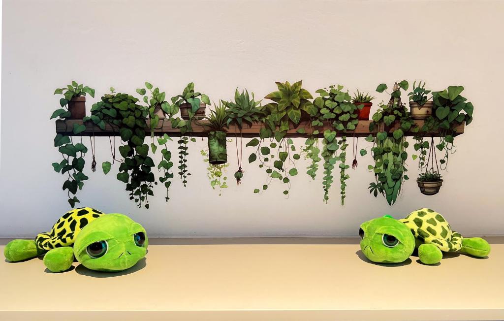 a shelf with potted plants on a wall at Roxy Beach Apartment, Sematan, Sarawak in Sematan
