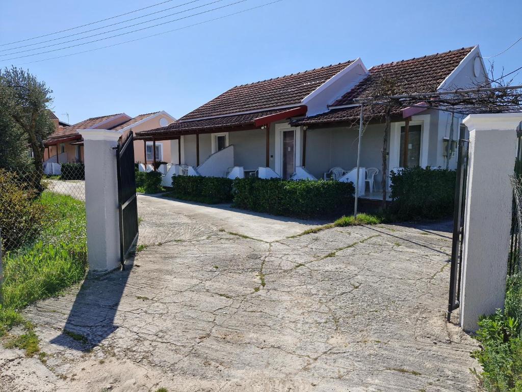 a house with a gate in front of it at Sidari Studios in Sidari