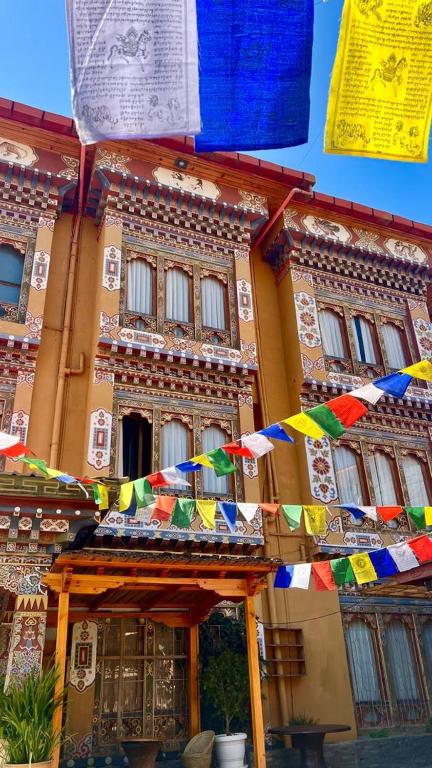 a building with colorful flags in front of it at Apartment in Thimphu