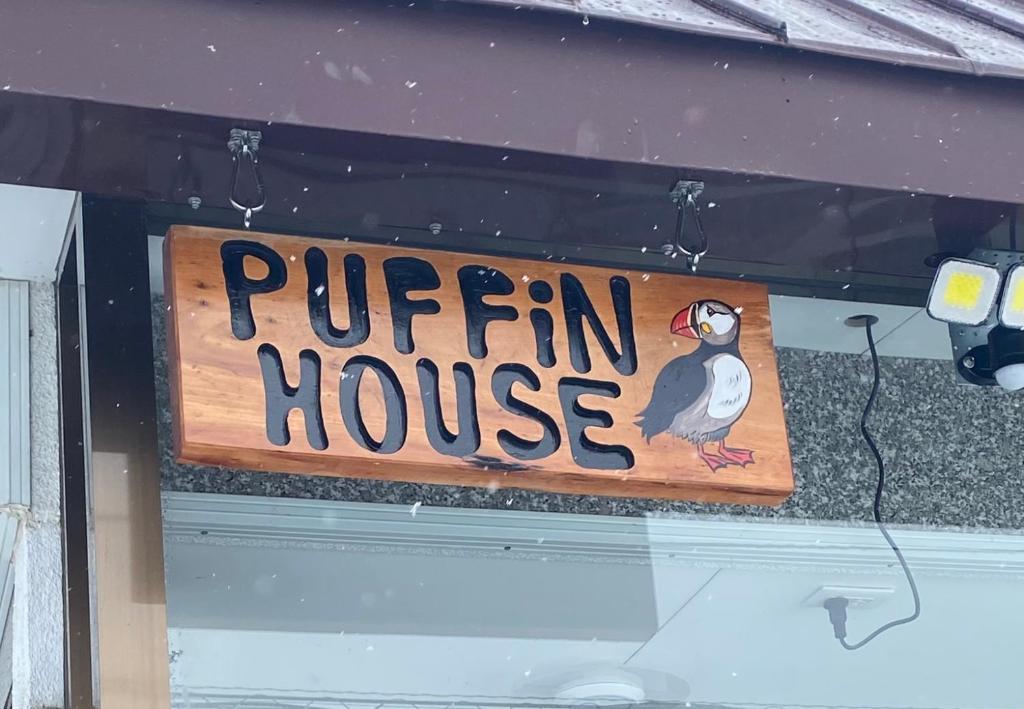 a sign for a puffin house with a bird on it at Puffin House in Engaru