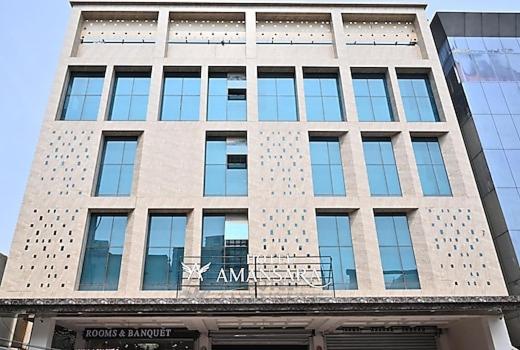 a tall building with a sign on the front of it at Hotel Amansara in Lucknow