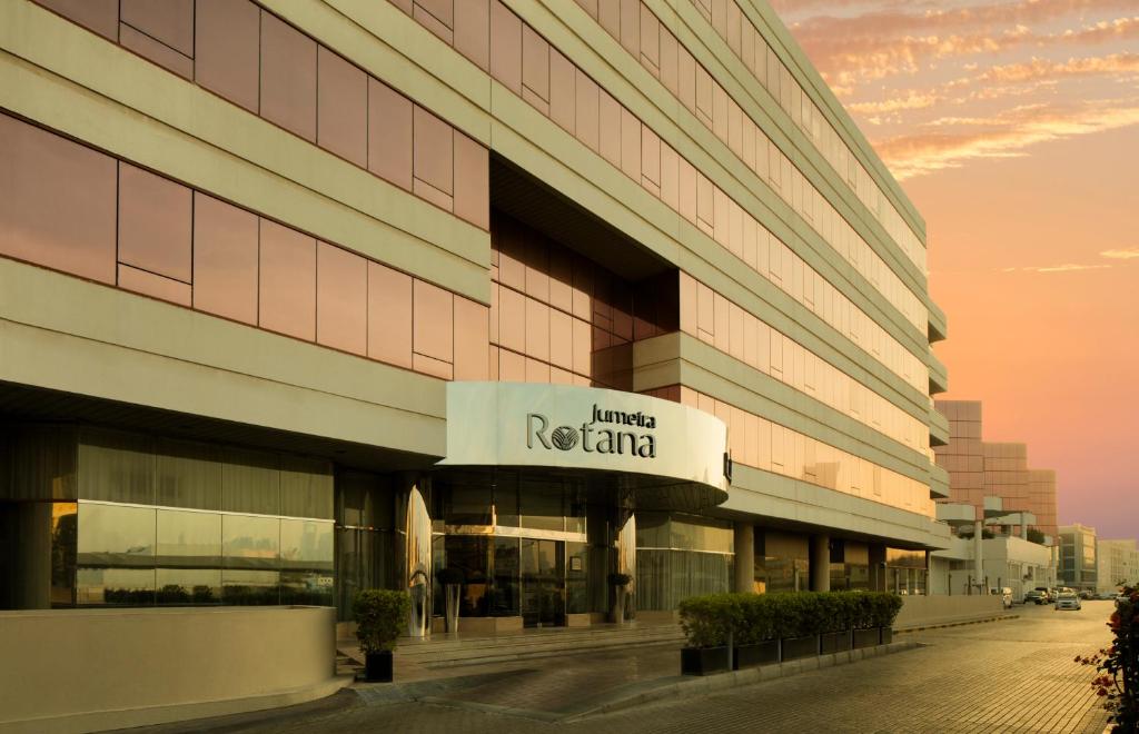 a building with a sign on the side of it at Jumeira Rotana – Dubai in Dubai