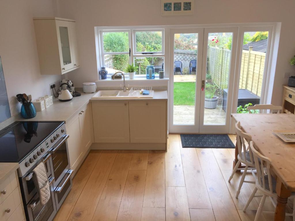 a kitchen with a sink and a stove top oven at Pearl Cottage in Blockley