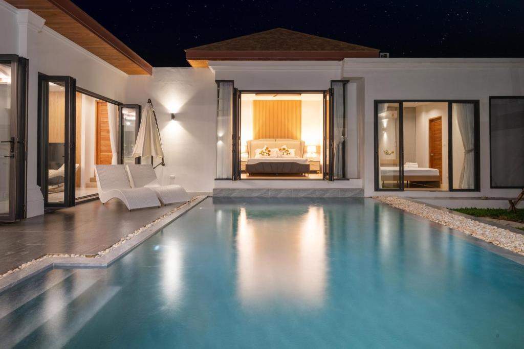 a swimming pool in a villa at night at lucky pool villas in Phuket