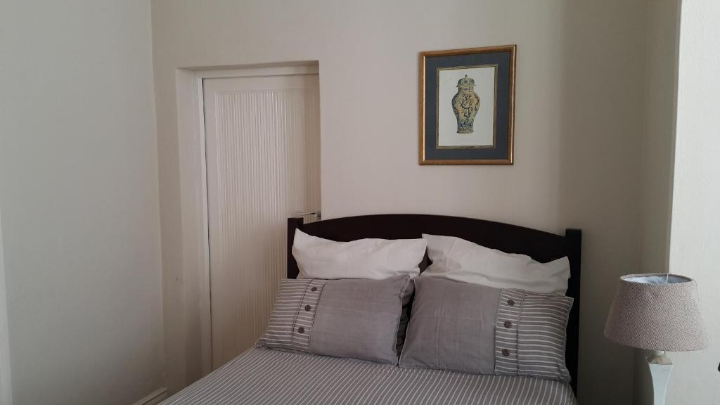 a bedroom with a bed with two pillows on it at Sommersby Bed & Breakfast in Durban