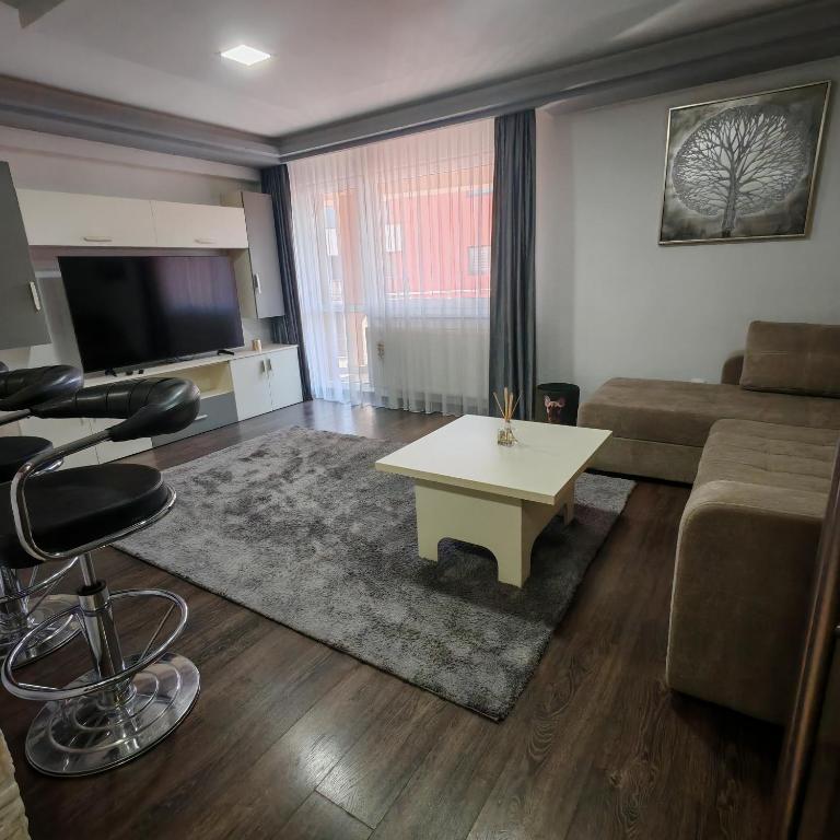 a living room with a couch and a table at Magic Apartments 3 in Miercurea-Ciuc
