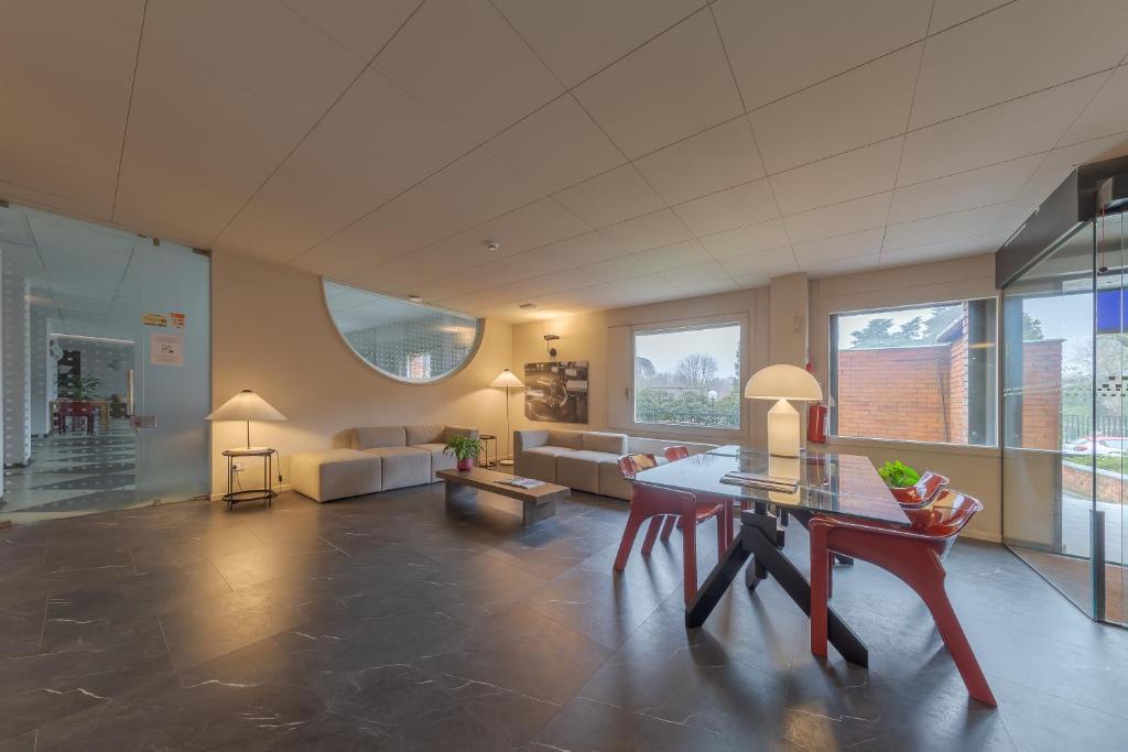 a large living room with a table and a couch at Residence Hotel Siloe in Milan