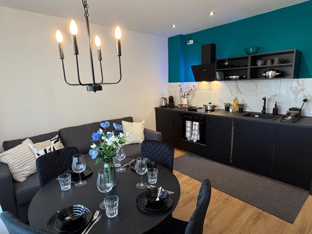 a dining room with a table and a kitchen at Home&Living - Casa Nova in Meerbusch