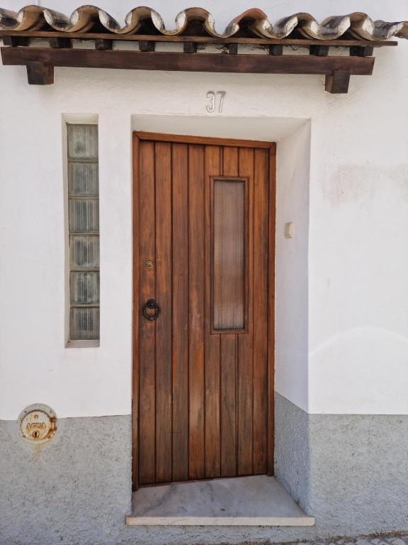 a wooden door on the side of a house at Casa Nelinha by Rosado in Luz