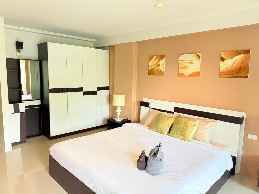 a bedroom with a large bed with two shoes on it at Aonang Mountain View A1 in Ao Nang Beach