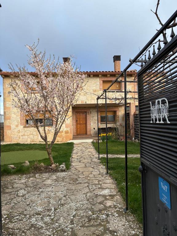 a house with a stone driveway in front of it at El Mirador de la Sierra Y Casa Rosmari in Urueñas