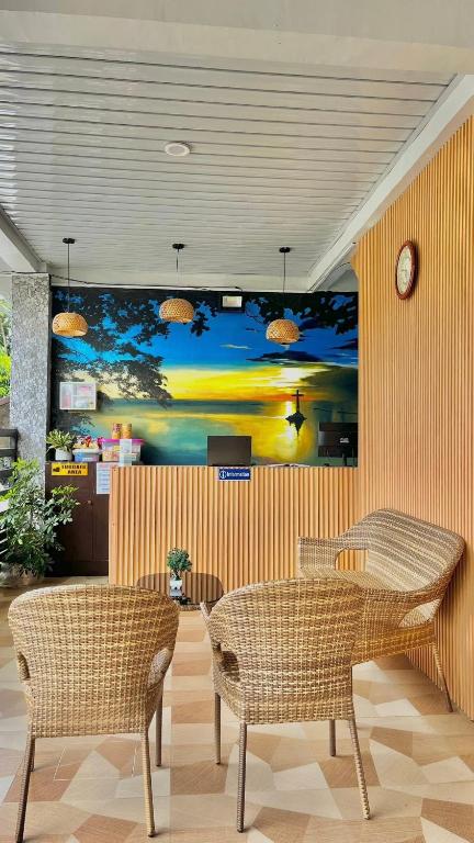 a dining room with a table and two chairs at Quartz Suites in Camiguin