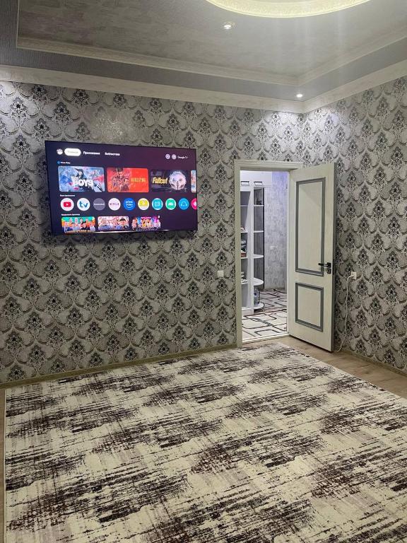 a living room with a tv on a wall at Seven Resedens 82-15 in Sergeli