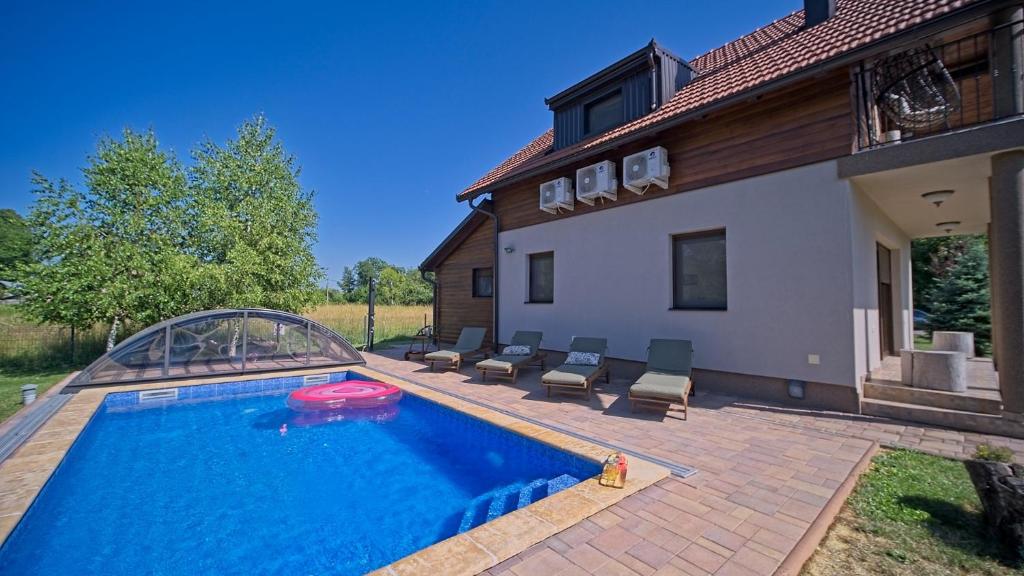 a swimming pool in the backyard of a house at Villa Debelo Brdo by Villas Guide in Debelo Brdo