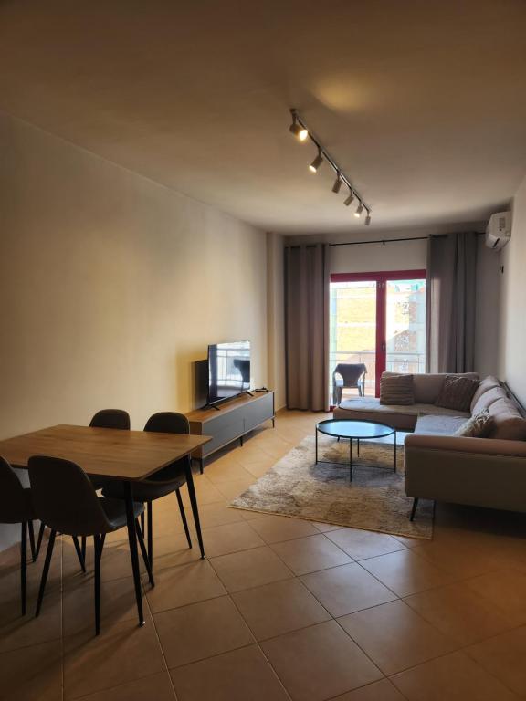 a living room with a couch and a table at Luxury Bruchi in Durrës