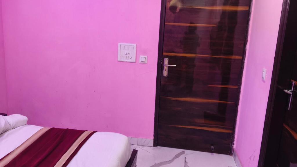 a room with a pink room with a door at Hotel rishav prime in Ghaziabad