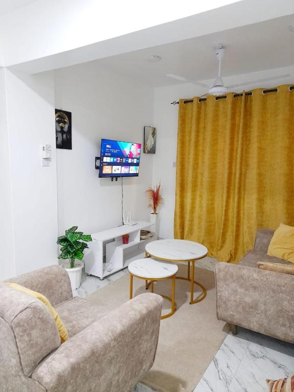 a living room with a couch and a table at Mwembeni Abode in Bamburi