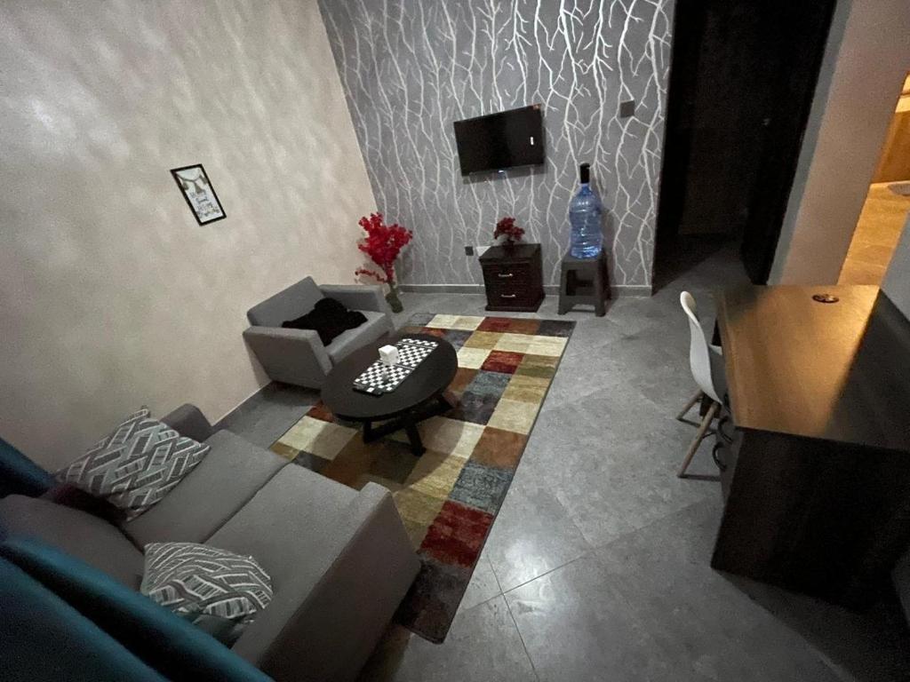 a living room with a couch and a tv at A Oasis Taveta in Taveta