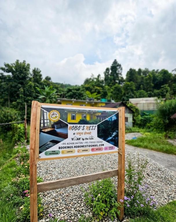 a sign on the side of a road at Hobo's Nest in Kurseong