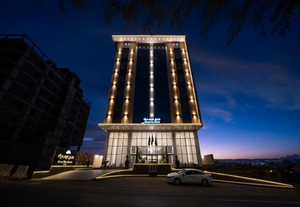 a car parked in front of a building at night at Grand Iva Hotel Abha in Abha