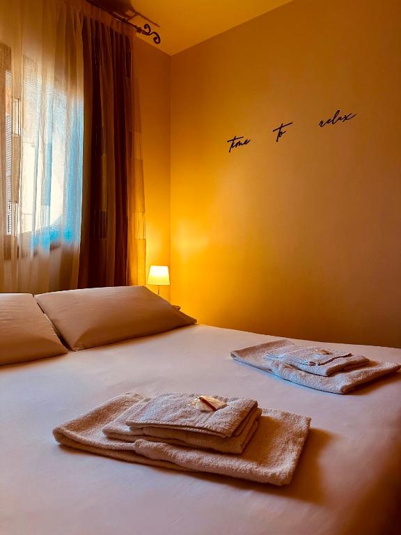 a bedroom with two towels on a bed at Blueberry Villa - Historic Center Lago Maggiore in Luino