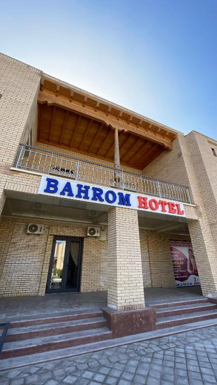 a building with a sign on the front of it at Bahrom Boutique Hotel in Khiva