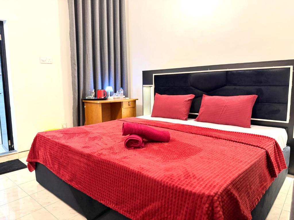 a bedroom with a bed with a red blanket at Home Stay Residence - Near Airport in Negombo