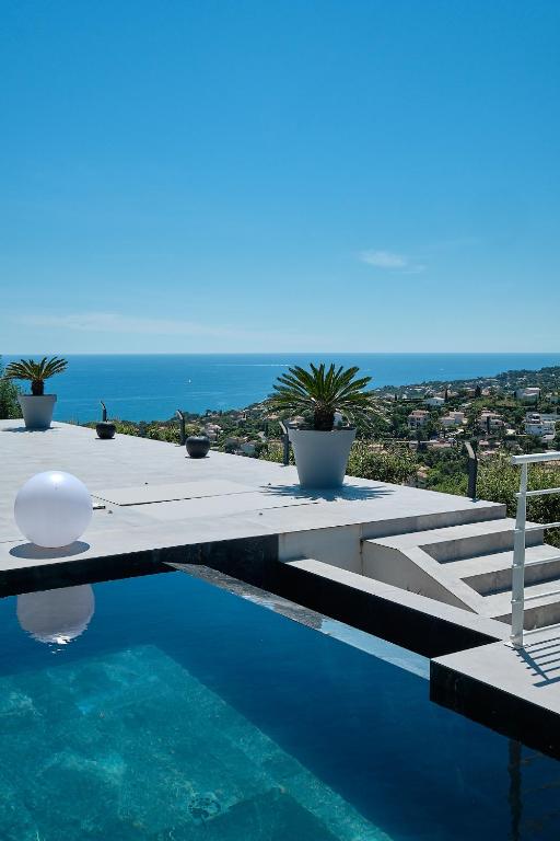 a swimming pool with a view of the ocean at Villa 259 in Roquebrune-sur-Argens