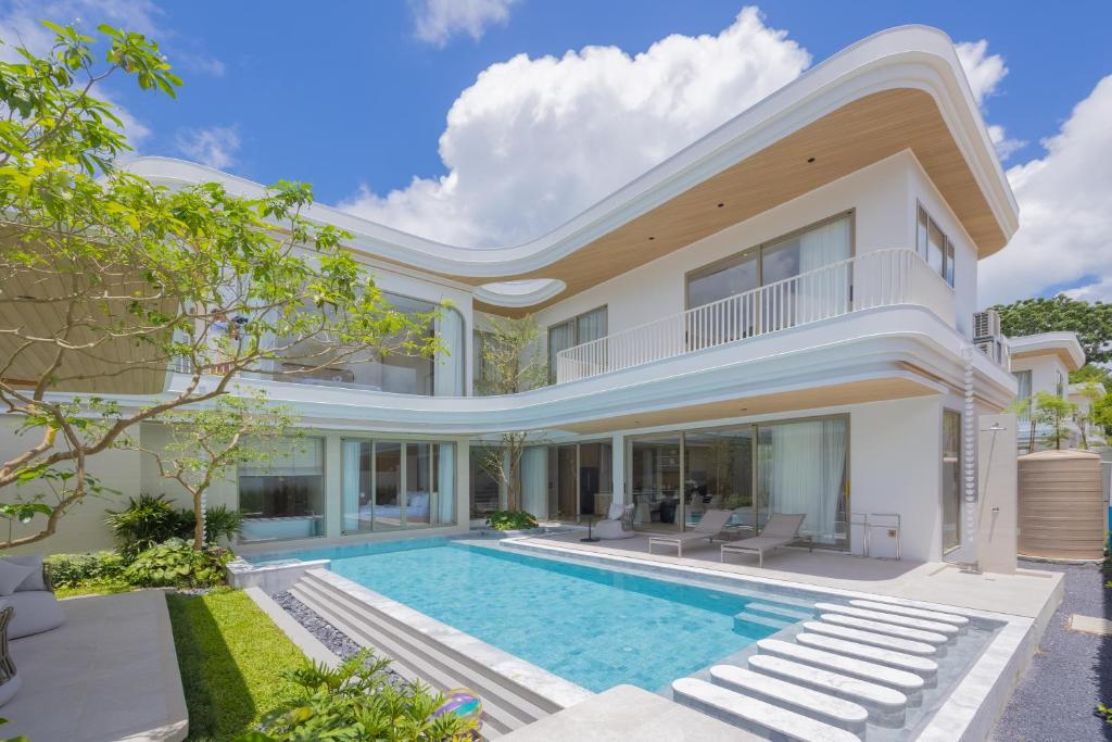 an exterior view of a house with a swimming pool at Nature's Rest Private Pool Villa Rawai in Rawai Beach