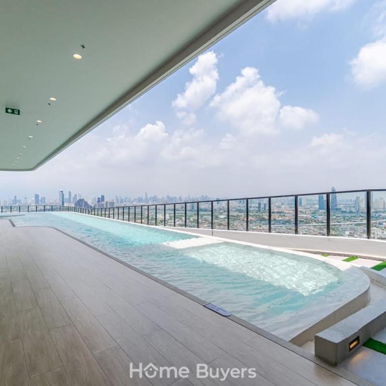 a large swimming pool on the top of a building at Xim Condo in Bangkok 20 mins to Asiantique in Ban Tha Hin