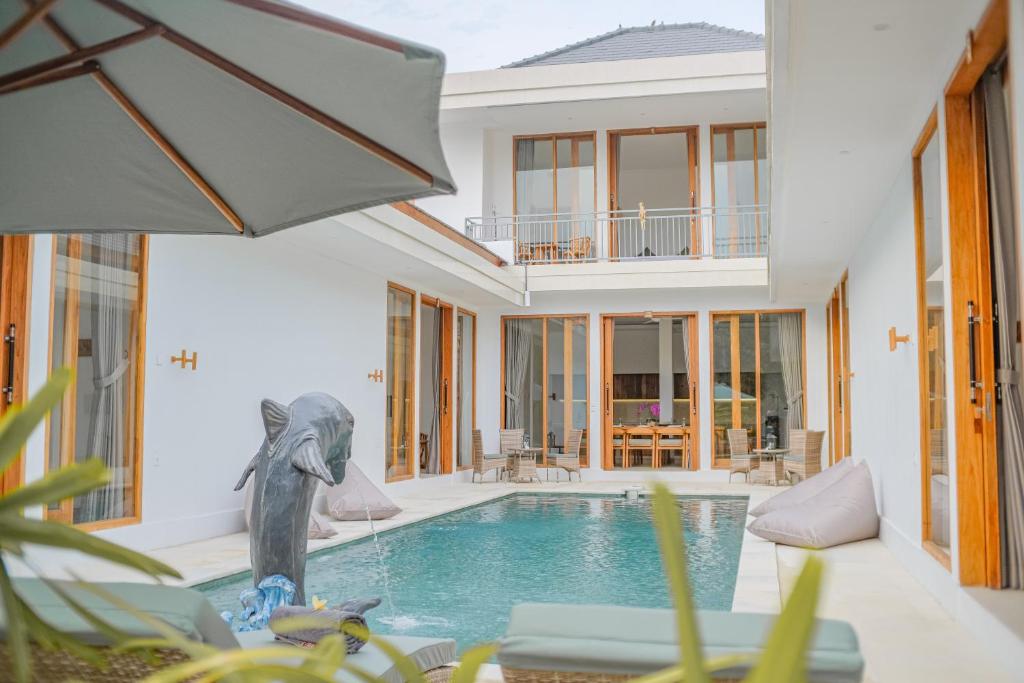 a villa with a swimming pool and a house at Dolphin - New luxury rooms in Lovina Centre & near the beach in Lovina