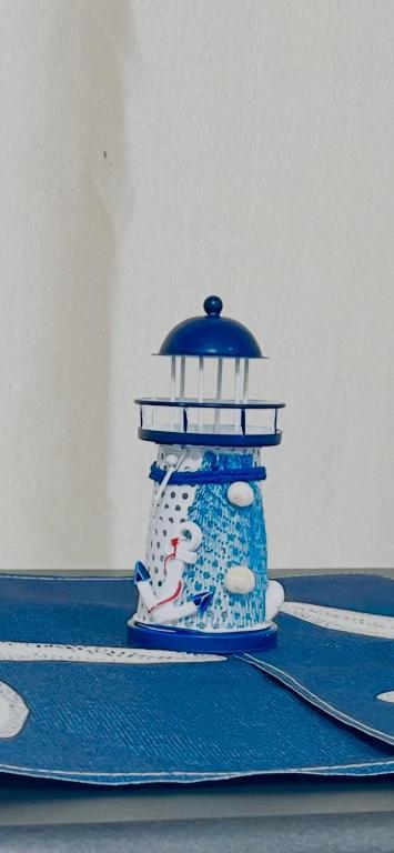a small figurine of a lighthouse on a table at Gwangalli #Modern #Korea in Busan
