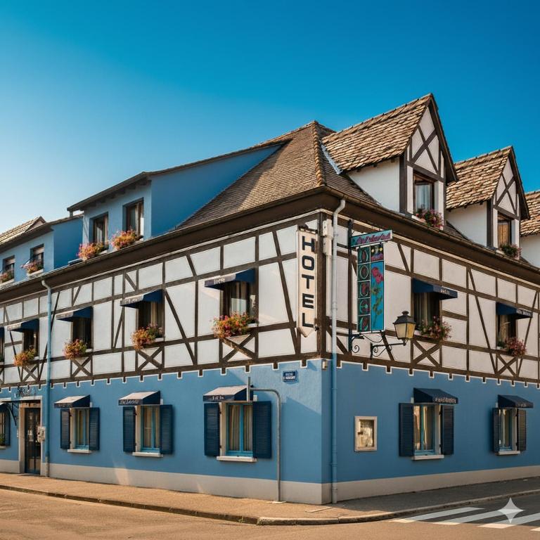 a blue and white building on a street at Hôtel Restaurant Aux Deux Roses in Neuf-Brisach