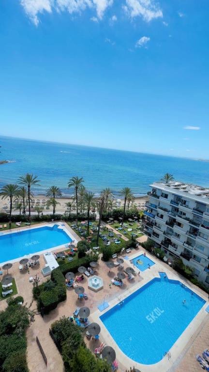 an aerial view of a resort with a pool and the ocean at Marbella Skol in Marbella