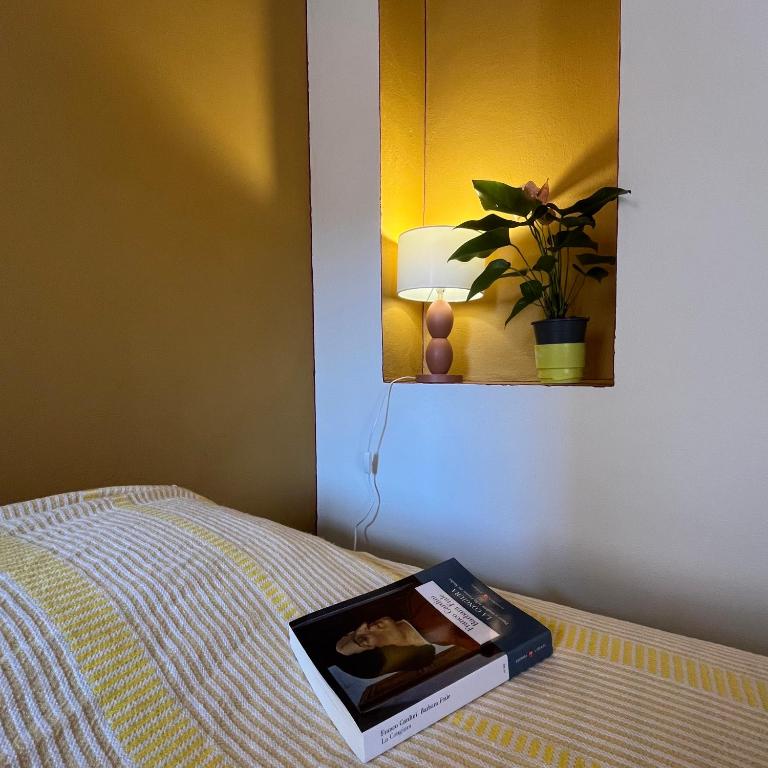 a book sitting on top of a bed at Cavour 66 Apartment in Ventimiglia
