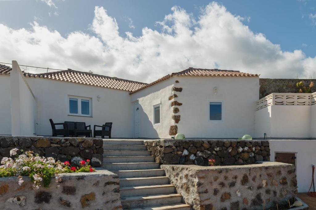 a white house with stairs in front of it at VV Casa Los Brezos "by AFCVacacional" in Breña Alta