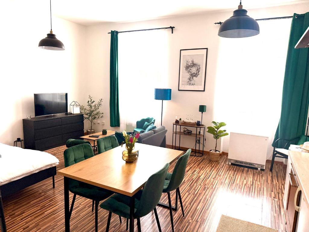 a living room with a table and chairs at Apartmán na Žerotínce in Šumperk