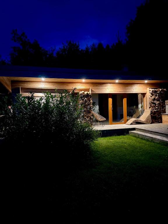 a house with lights on it at night at Za kovárnou in Zděchov