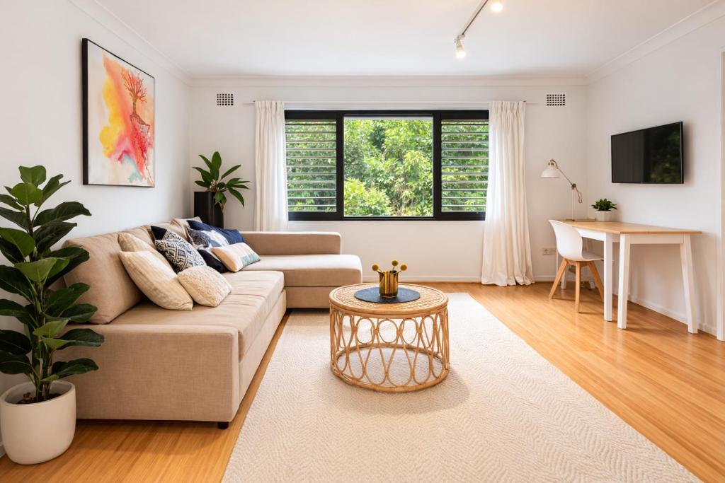 a living room with a couch and a table at Coastal Stay in Cronulla