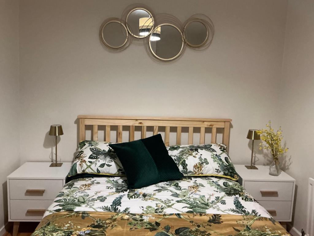 a bedroom with a bed with olympics on the wall at Rose Cottage Moira in Moira