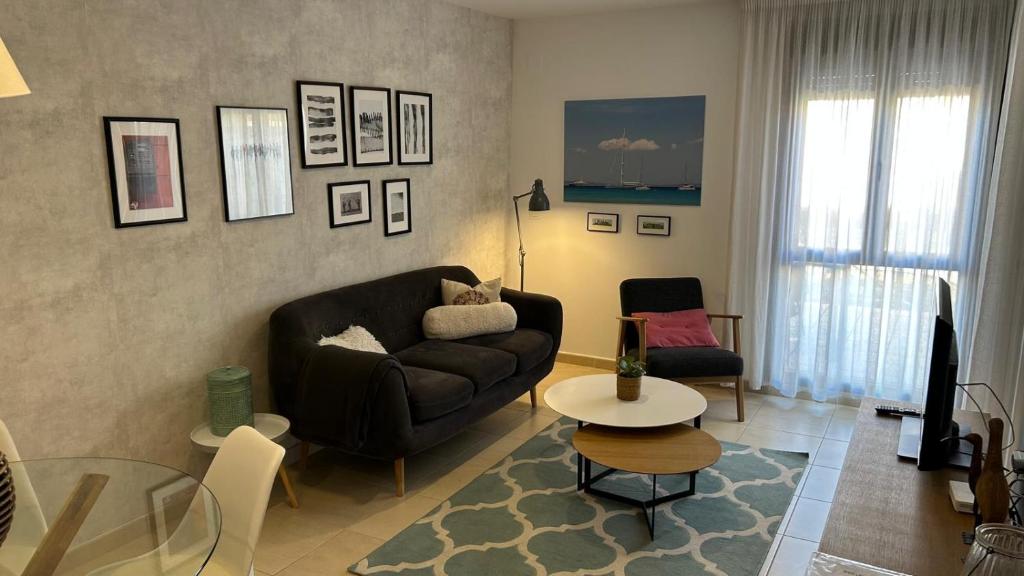 a living room with a couch and a table at Apartamento La Calma in Lliber