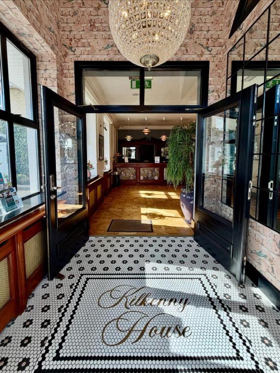 a room with a door with a sign on the floor at Kilkenny House Boutique Hotel in Kilkenny