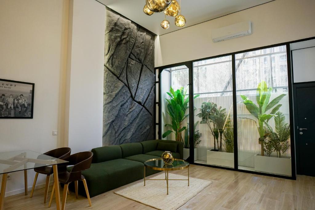a living room with a green couch and a glass table at Cliff Appart in Valencia
