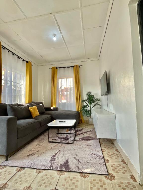 a living room with a couch and a table at Jenka homes in Kitui