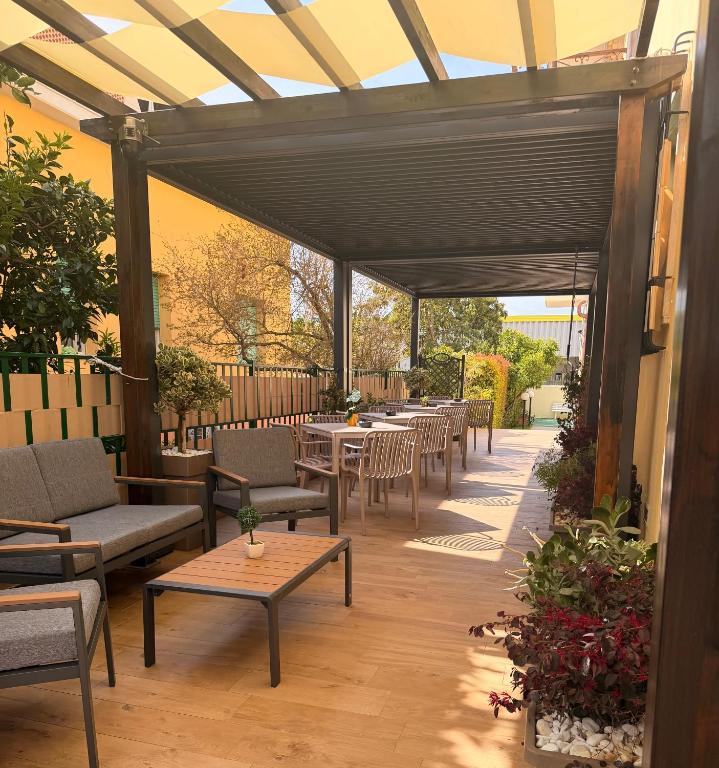 an outdoor patio with tables and chairs and awning at B&B Villa degli Angeli in Praia a Mare