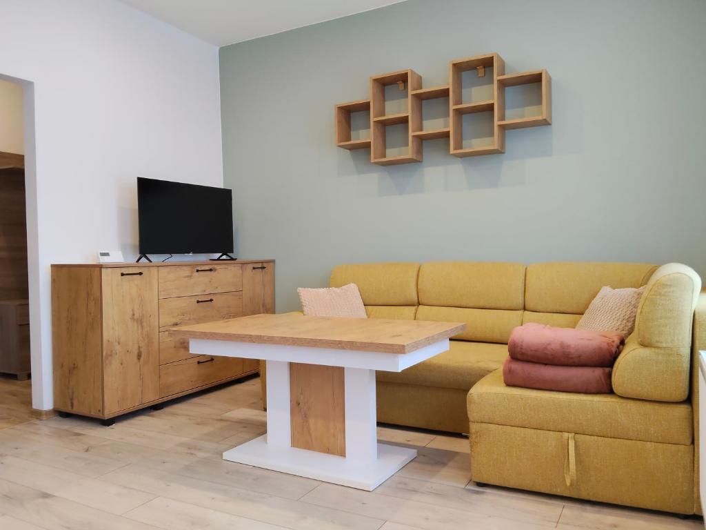 a living room with a couch and a table at Pod Dzikowcem in Boguszów-Gorce