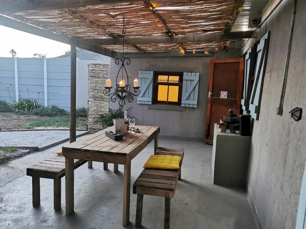 a patio with a wooden table and two benches at Iewers Rus in Strand