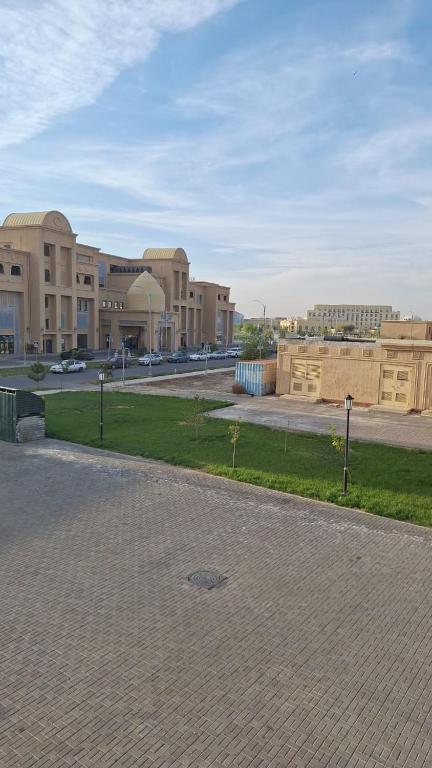 a large building with a parking lot in front of it at ЖК 2 Keruen Saray in Türkistan
