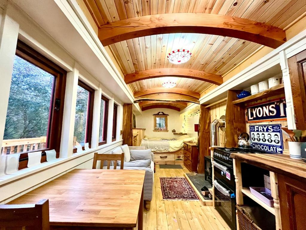 a living room with a wooden table in a house at Mòr Braw in Banavie